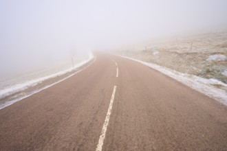 Gentle curve of a road in thick fog, winter, Route de Cretes, Hohneck, La Bresse, Vosges, France