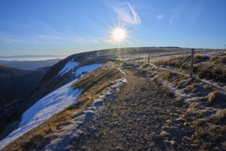 Snowy trail on a ridge at sunrise, clear view with frosty landscape, winter, Route de Cretes,