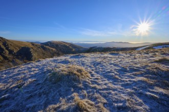 A frosty landscape under bright sunlight and a clear blue sky, winter, Route de Cretes, Hohneck, La