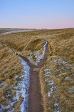 Fork in a slightly snow-covered hilly landscape under a blue and pink sky, La Gorge de Pierrel,