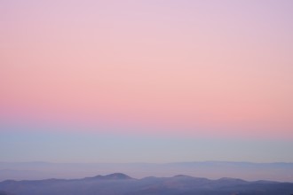 Mountains under a clear sunset sky in pastel shades of pink, purple and blue, viewing, Rhine