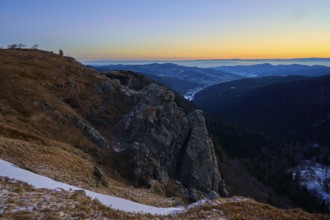 Rocky elevation with wide horizon at sunset, looking towards the Rhine Valley, viewpoint, La Gorge