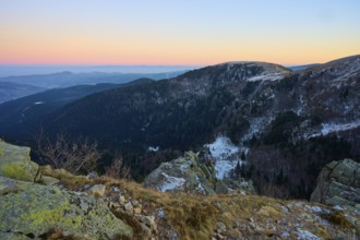 Snowy hills and rocks in warm evening light, view of the Rhine Valley, viewpoint, La Gorge de