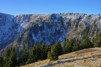 Snowy rock face with trees below in bright sky, viewpoint, Martinswand, Frankental, Vosges, France