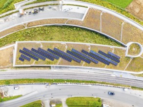 Solar panels on a flat roof surrounded by roads and vegetation, new park and ride car park Calw