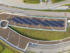 Aerial view of a solar roof in an urban area surrounded by roads, new park and ride parking garage