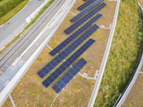 Close-up of solar panels on a green hill in urban surroundings, new park and ride car park Calw