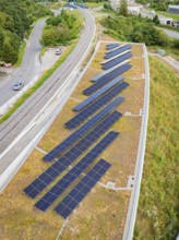 Distribution of solar modules on roof near railway tracks in urban surroundings, new Park and Ride