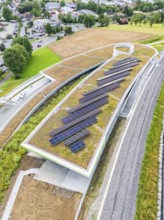 Roof with solar systems near roads and train lines, nestled in nature, new park and ride parking