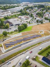 View of urban landscape with solar panels and road traffic, new park and ride car park Calw