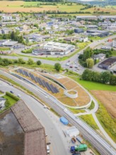 Overview of a commercial area with solar systems nestled in rural surroundings, new park and ride