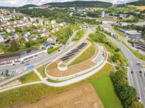Wide city view with solar panel system and dense vegetation, new park and ride car park Calw