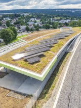 Solar system on a green roof with a view over an urban landscape, new park and ride parking garage