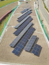 Solar panels on a roof viewed from above, surrounded by buildings, new park and ride parking garage