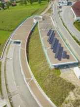 Round road layout next to solar panel system on a roof, new Park and Ride Calw Heumaden car park on