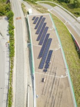 Top view of solar panel system surrounded by roads and vegetation, new park and ride car park Calw