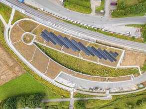 Aerial view of a solar system on an architecturally designed building in rural surroundings, new