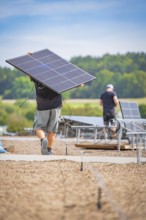 Workers transport and install solar panels in the open air, new park and ride Calw Heumaden car