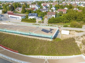 View of a solar panel in an urban area with houses and green surroundings, new park and ride