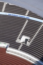 Modern stadium stand with empty seats, outdoor stairs and tartan track, Helsinki Olympic Stadium,