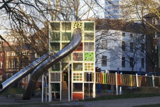 Children's playground with colorful climbing tower and slides, Immanuel-Kant-Park, Duisburg, North