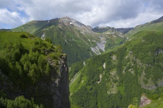 Green mountains under blue sky with clouds, peaceful summer day in nature, mountainous landscape