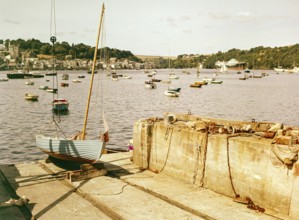 Boats at moorings in harbour of town Fowey, Cornwall, England, UK view across River Fowey estuary