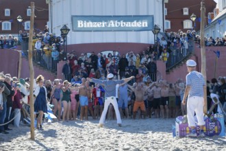 Tourists waiting in front of the spa hotel to bathe, swimmers ready to start in the water, tourist