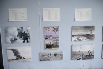 Wall with war pictures and documents in black and white in the partisan museum in the old school of