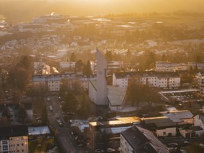 Church architecture in urban area at sunset surrounded by other buildings, Calw, Black Forest,