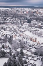 Snowy city view with many houses and trees in winter, Calw, Black Forest, Germany