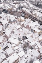 Roof view of snow-covered half-timbered houses in a historic town, Calw, Black Forest, Germany