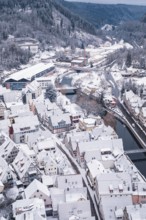 Snowy cityscape with river, bridge and hilly surroundings in the background, Calw, Black Forest,