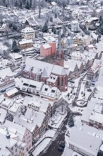 Snowy town with a distinctive church surrounded by traditional architecture, Calw, Black Forest,
