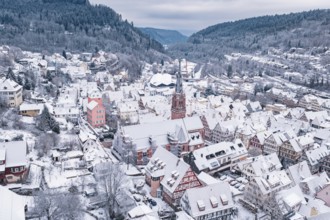 Snowy old town with church and half-timbered houses in a scenic area, Calw, Black Forest, Germany