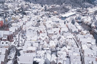 Snowy urban scene with traditional buildings and wintry atmosphere, Calw, Black Forest, Germany