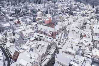 Church buildings surrounded by a snowy town with traditional architecture in winter, Calw, Black