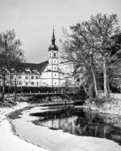 The island channel on the banks of Lake Constance with the Christ Church of St. Konrad, black and