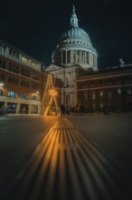 Illuminated St Paul Cathedral with decorated Christmas tree and festive night atmosphere, London,