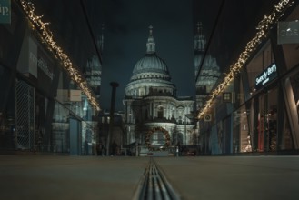 Illuminated St Paul Cathedral between modern glass facades with festive lighting, London, England,