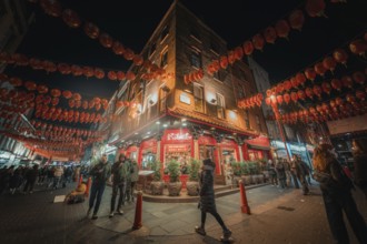 Bustling street scene in Chinatown with red lanterns, China Town, London, England, Great Britain