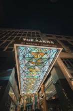 Entrance with modern geometric design and colorful lights at night, London, England, Great Britain