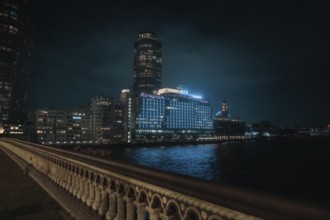 City view at night with glowing buildings and a bridge over a river, London, England, Great Britain