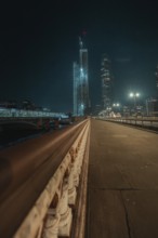 Night scene of an illuminated bridge with skyscrapers in London, London, England, Great Britain