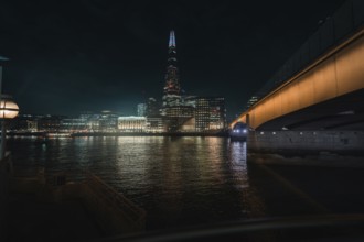 Night view of city with illuminated bridge and shard in background, London, England, Great Britain