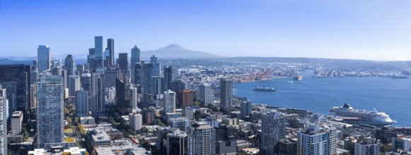 Panoramic Seattle financial district skyline in city downtown with Mount Rainier in the background