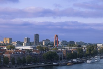 Willemsbrug Bridge in Rotterdam financial business center. Skyline panorama over Nieuwe Maas river