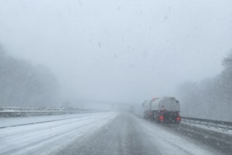 View through the windshield of a passenger car in poor visibility Driving through light snowblowing