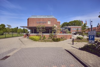 Town hall, brick building, modern architecture, flat roof, parking space for the disabled, barrier