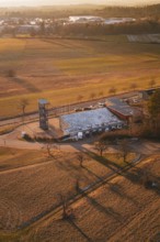Fire station in a rural winter landscape with long shadows and snow-covered fields, Althengstett,